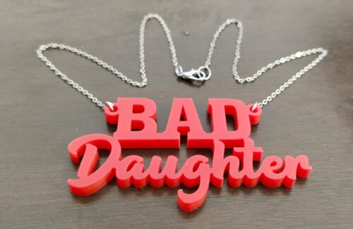 Bad Daughter necklace, a perfect gift for feminists in your life. Available in red and orange.