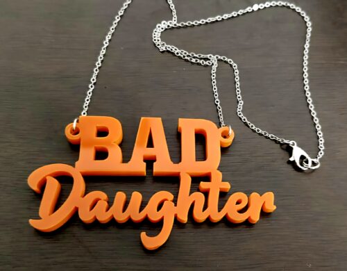 Bad Daughter necklace, a perfect gift for feminists in your life. Available in red and orange.